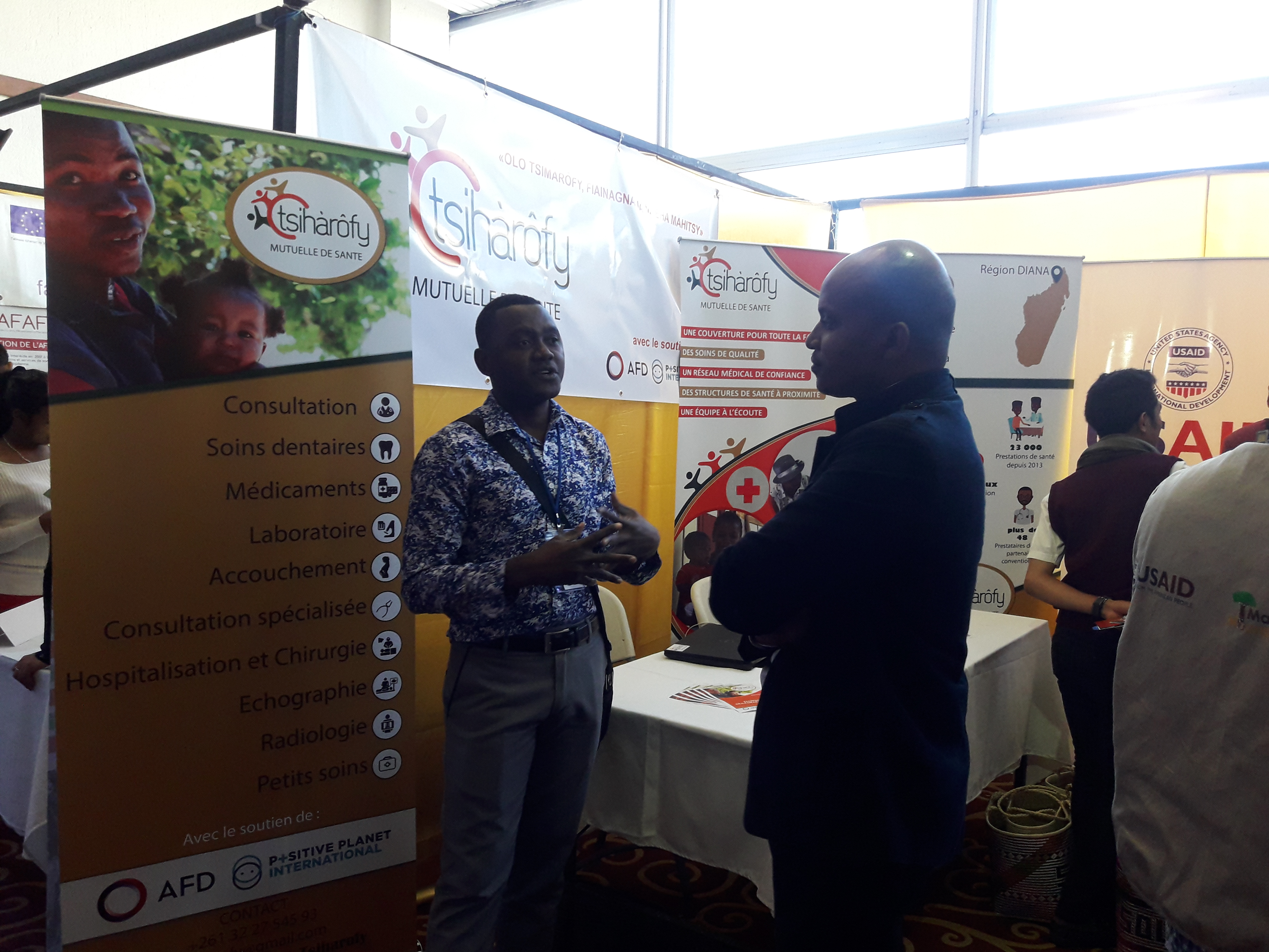 People talking at a booth