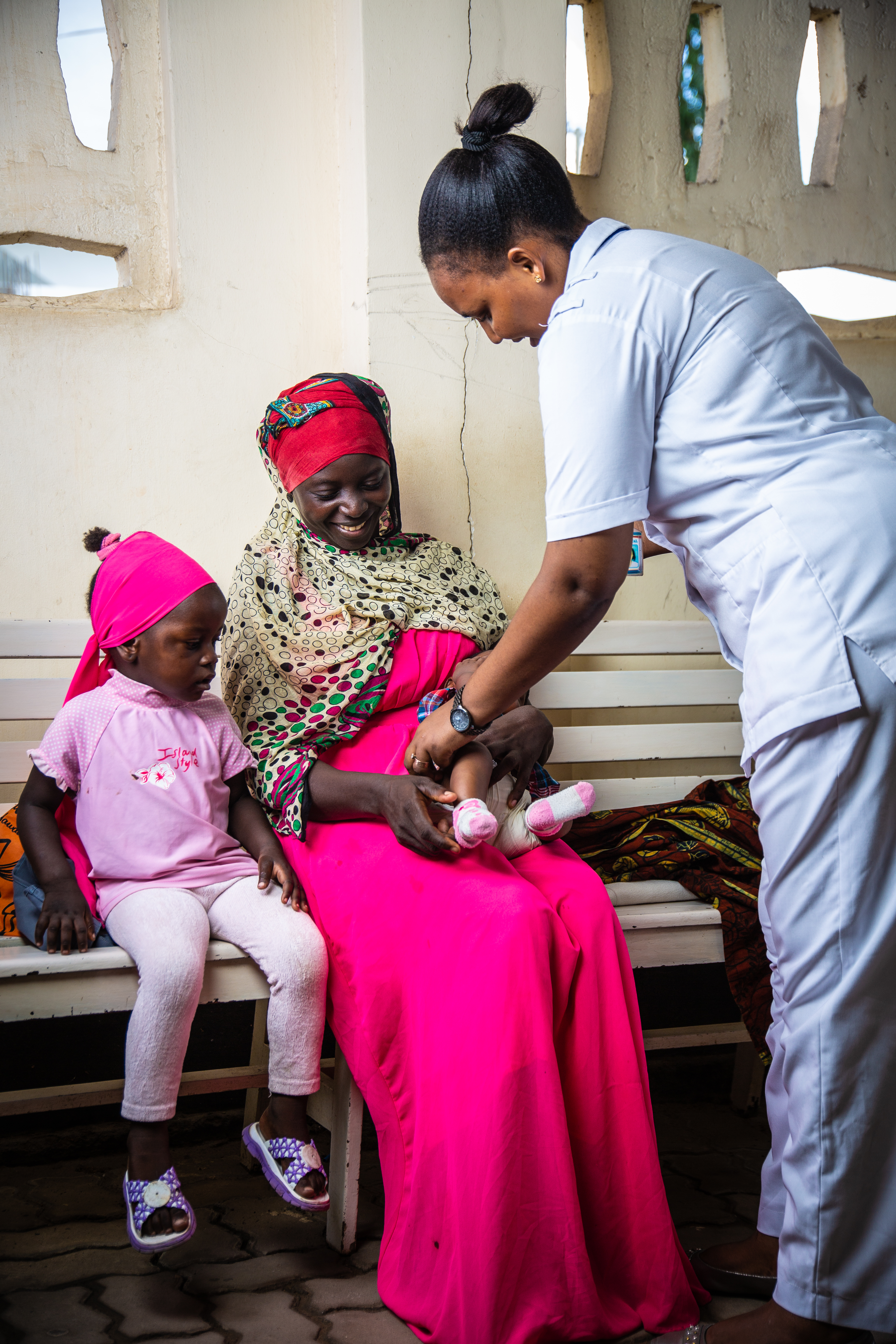 A mother with two children and a nurse