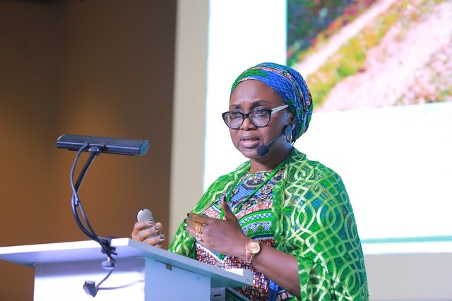 Amina Aminu talking from a podium at the conference