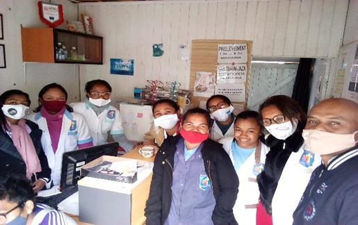 A group of 9 people wearing face masks