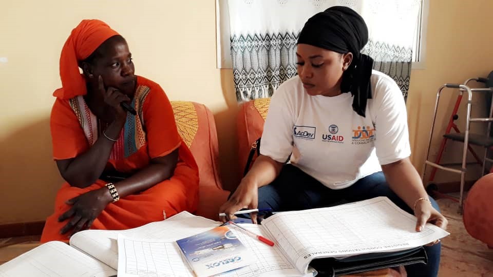 Midwife, Diallo, sitting with a client