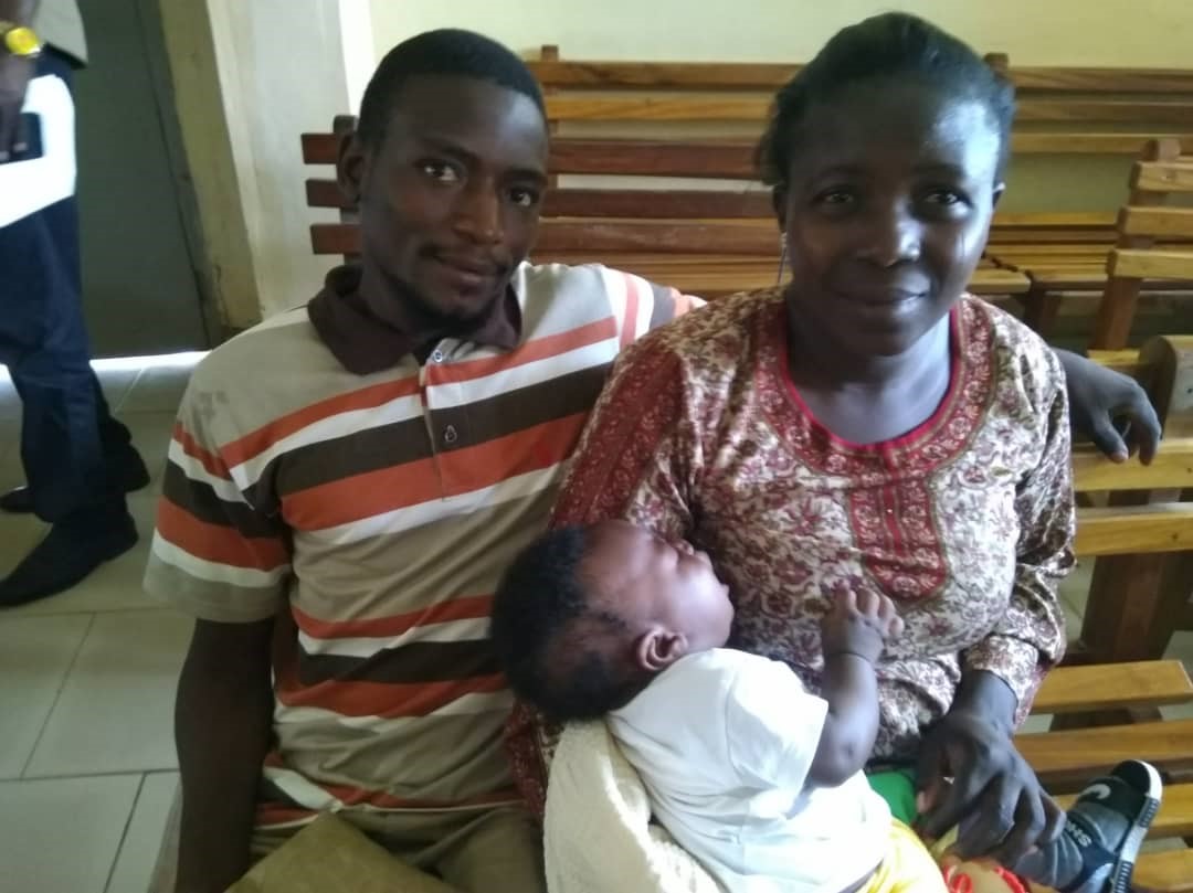 Samson Yenlong and his wife holding one of their three children.