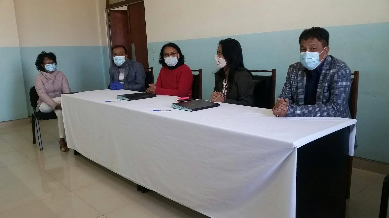 Image of four people at a signing