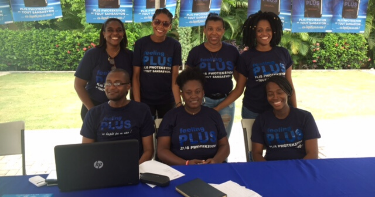 Staff gather for a picture wearing Feeling Plus Condom t-shirts