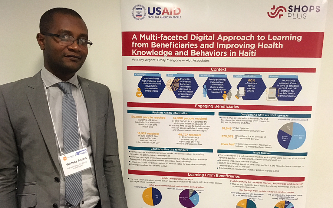 Argant standing next to his poster at the forum.