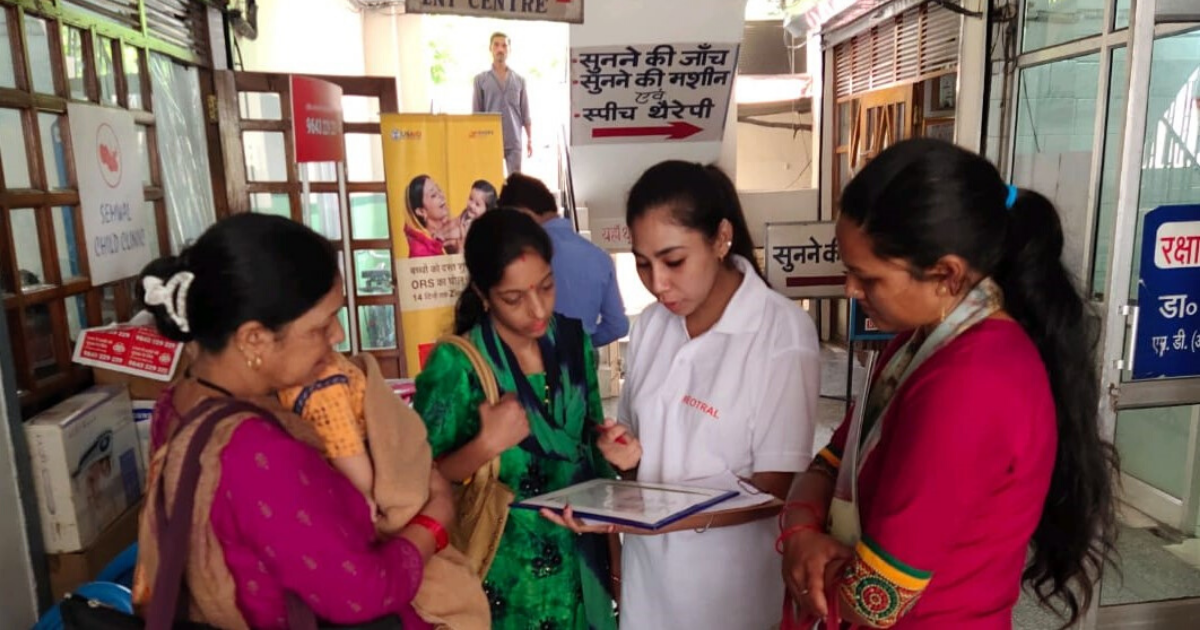 Women gathered around reading a document