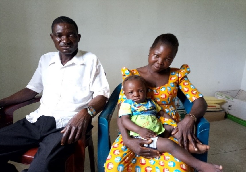 Photo of Kassam, a 41-year-old farmer, with his wife and young daughter.