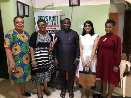 Four women and one man posing for a picture