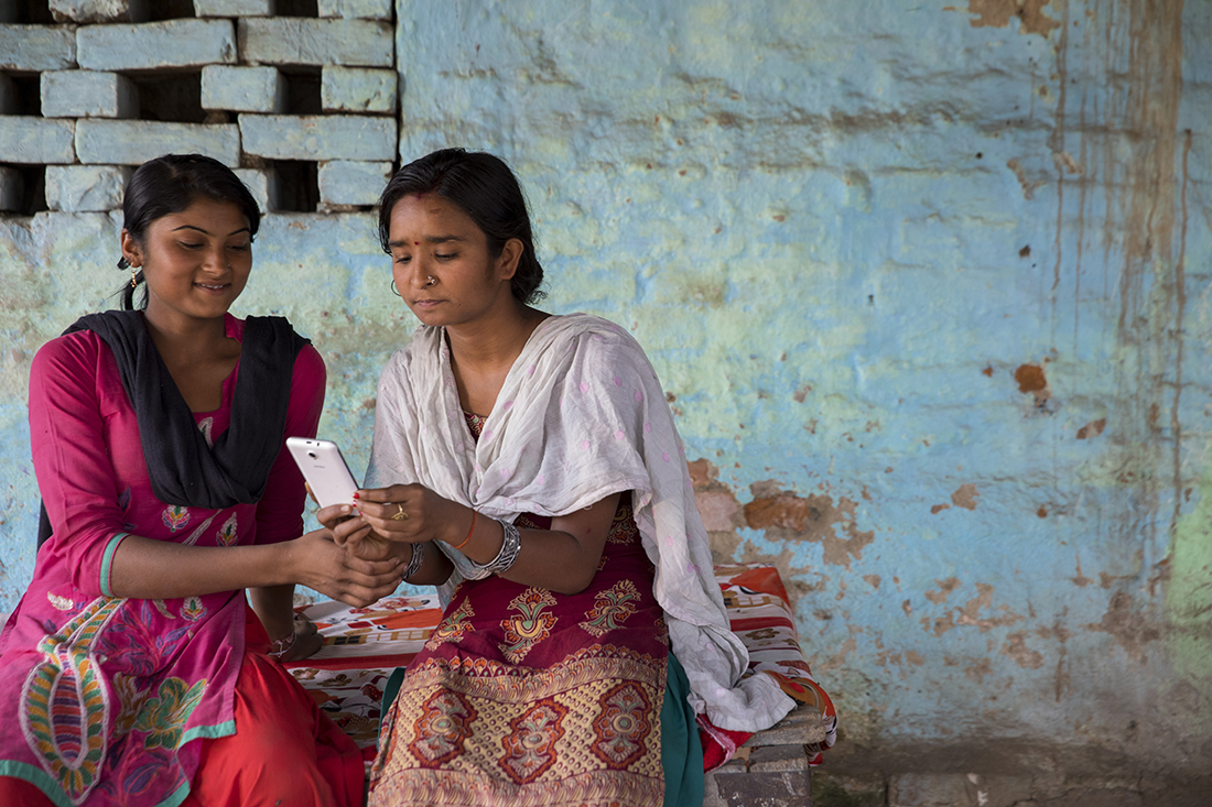 Two Indian women sitting on a bench