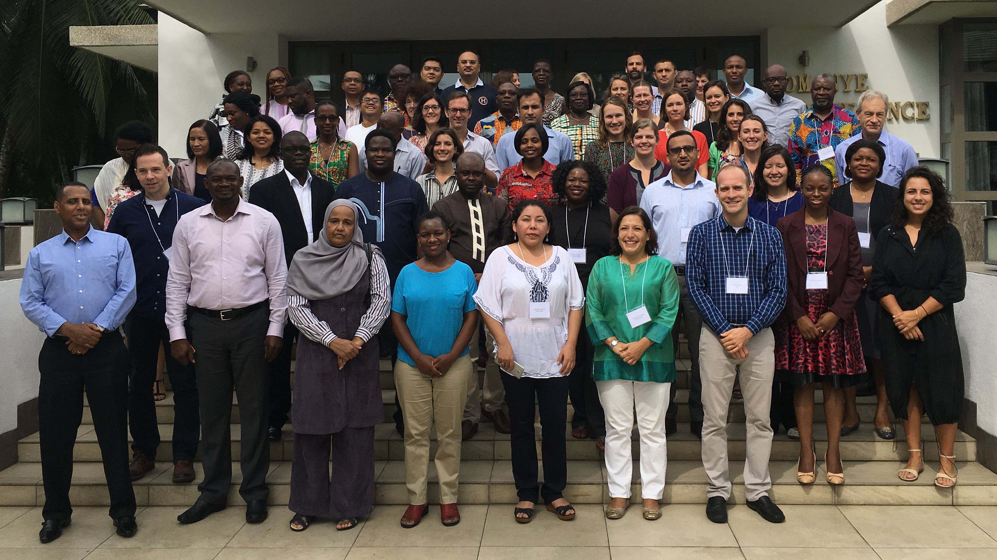 All social franchising workshop attendees pose on the steps outside the workshop facility.