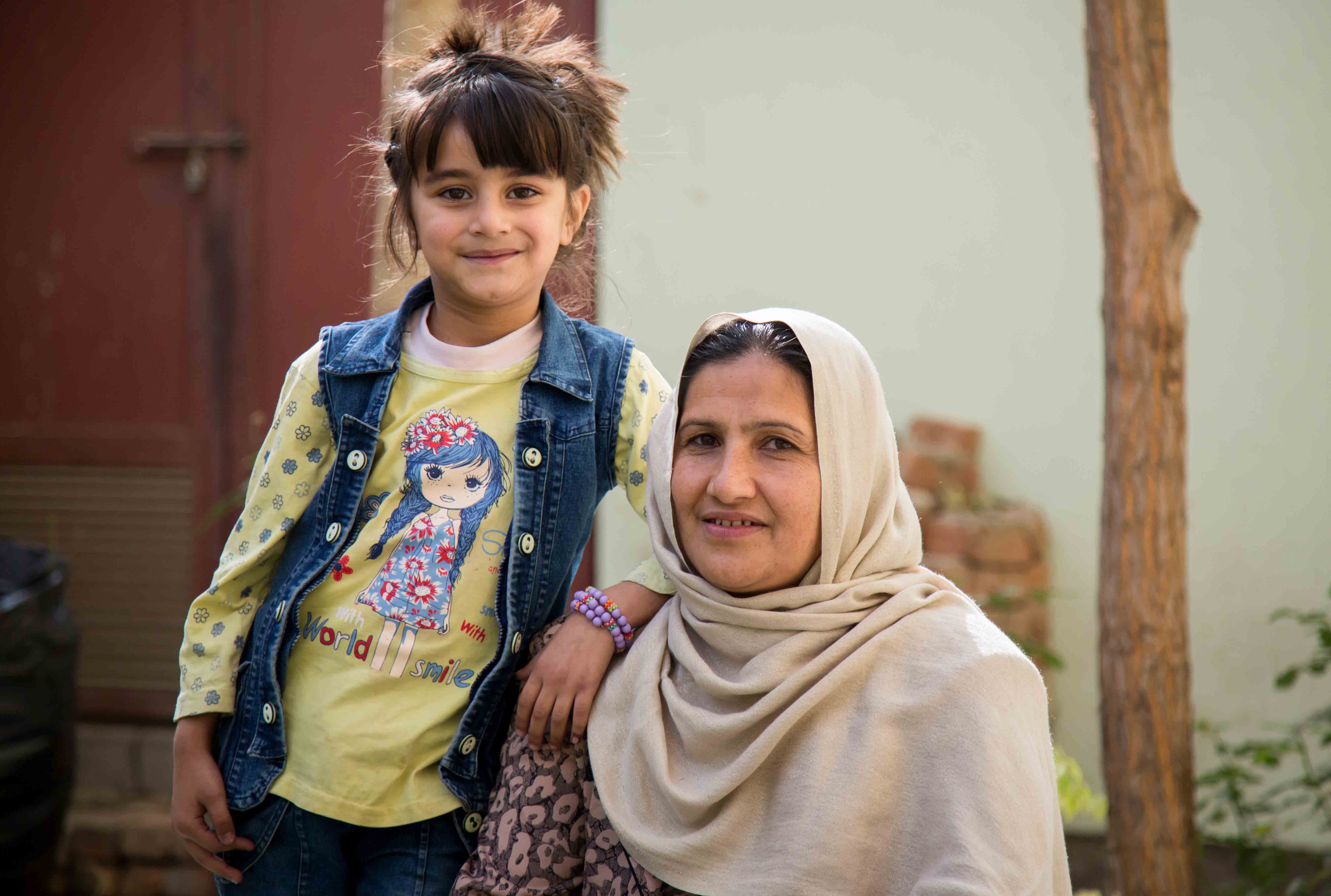 Mother and daughter posing for a photo