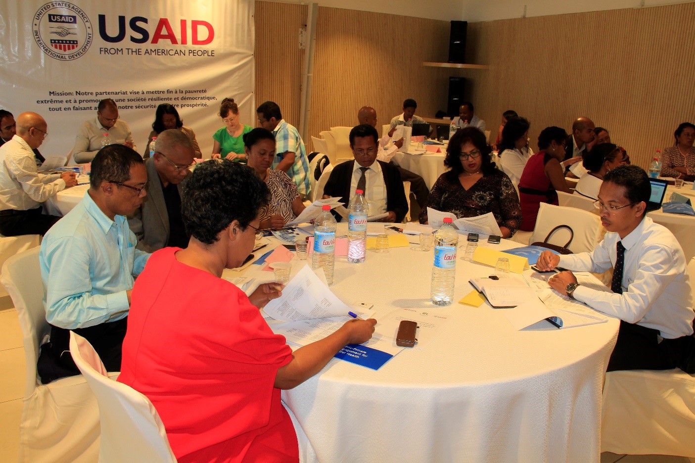 Stakeholders during a break out session talking around a table. 