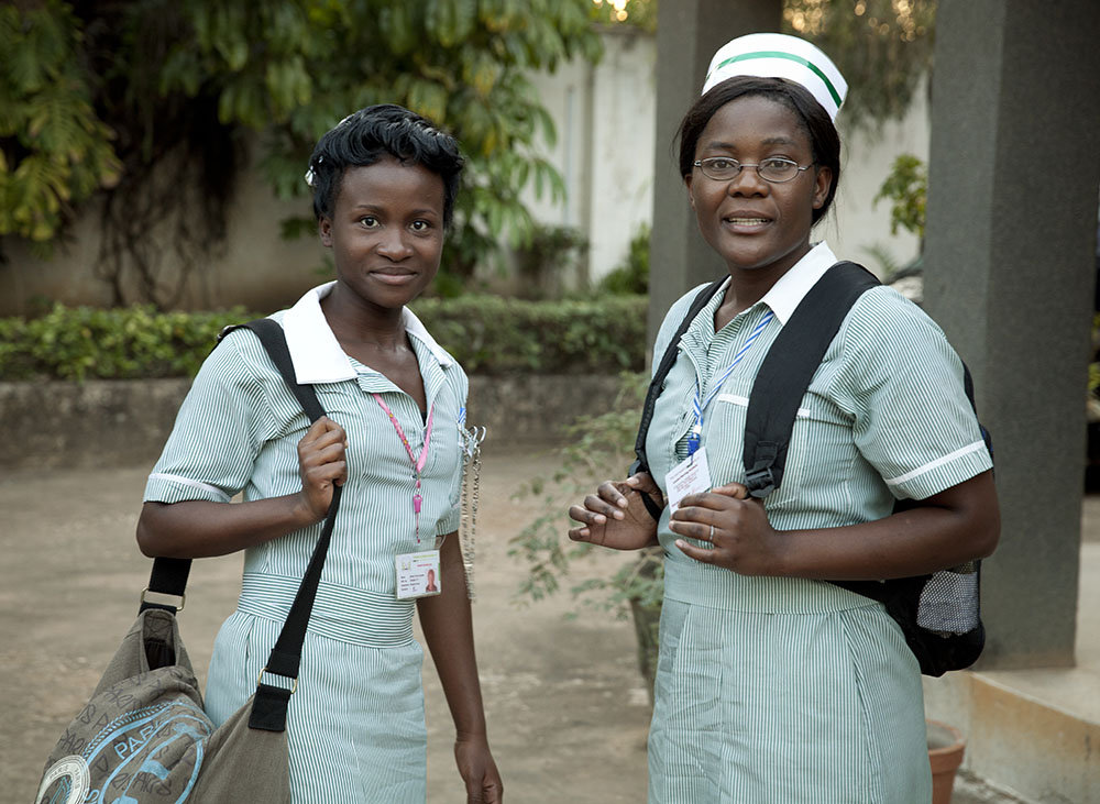 Two nurses standing in uniform.