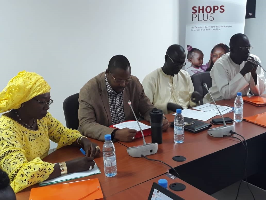 Picture of four participants, including Isseu, sitting at a desk at the workshop. 